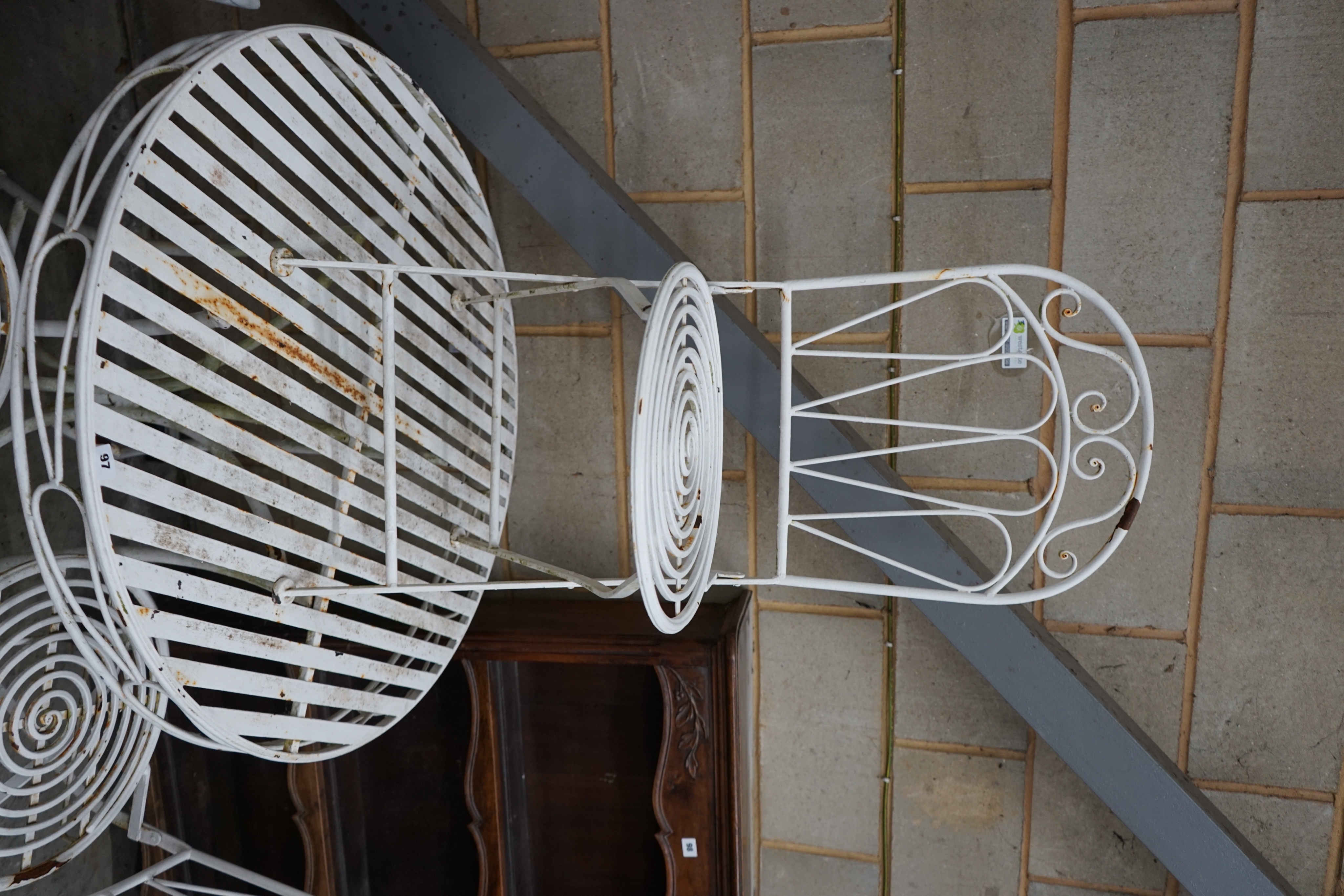 A circular metal garden table and three folding chairs, table diameter 90cm height 76cm